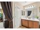 A second view of the well-lit bathroom with double sinks and decorative fixtures at 7734 W Terri Lee Dr, Phoenix, AZ 85035