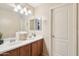 Bright bathroom featuring a double sink vanity, neutral walls, and vanity lighting at 7734 W Terri Lee Dr, Phoenix, AZ 85035