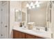 Bright bathroom with double sinks, vanity lighting, and neutral walls at 7734 W Terri Lee Dr, Phoenix, AZ 85035