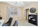 A cozy bedroom features a large window, accent furniture and a decorative bookshelf at 7734 W Terri Lee Dr, Phoenix, AZ 85035