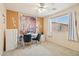 Bright bedroom with a home office setup with SPA and GYM motivational signs and large bright window at 7734 W Terri Lee Dr, Phoenix, AZ 85035