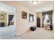 Carpeted bedroom featuring window with blinds, and view into hallway and Primary bedroom at 7734 W Terri Lee Dr, Phoenix, AZ 85035