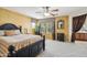 Spacious bedroom with textured wallpaper, a ceiling fan, and an adjacent bathroom area at 7734 W Terri Lee Dr, Phoenix, AZ 85035