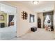 Neutral bedroom featuring carpeted floors, a window, an interesting wall mirror, and a display shelf at 7734 W Terri Lee Dr, Phoenix, AZ 85035