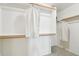 A spacious, well-lit walk-in closet with ample storage and shelving at 7734 W Terri Lee Dr, Phoenix, AZ 85035
