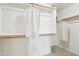 Spacious walk-in closet with built-in shelving and ample storage for organized clothing at 7734 W Terri Lee Dr, Phoenix, AZ 85035