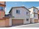 This two-story home has a two-car garage, desert landscaping, and stucco facade in a gated community at 7734 W Terri Lee Dr, Phoenix, AZ 85035