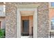 Inviting entryway with a decorative stone surround and a secure front door at 7734 W Terri Lee Dr, Phoenix, AZ 85035