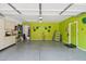 An organized garage boasts green walls and functional storage space, with epoxy floors at 7734 W Terri Lee Dr, Phoenix, AZ 85035