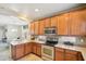 Modern kitchen with stainless steel appliances, wooden cabinetry, and easy access to the dining area at 7734 W Terri Lee Dr, Phoenix, AZ 85035