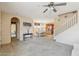 Open-concept living space with carpet, archways, and views into the dining area at 7734 W Terri Lee Dr, Phoenix, AZ 85035
