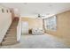 Spacious living room with staircase, neutral tones, comfortable seating, and ample natural light at 7734 W Terri Lee Dr, Phoenix, AZ 85035