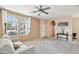Bright living room features neutral color palette, arched windows and access to other rooms at 7734 W Terri Lee Dr, Phoenix, AZ 85035