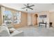 Bright and airy living room featuring neutral colors, large windows, and comfortable seating area at 7734 W Terri Lee Dr, Phoenix, AZ 85035