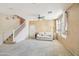 Bright living room featuring a comfortable sofa, ceiling fan, and arched windows at 7734 W Terri Lee Dr, Phoenix, AZ 85035