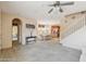 Open-concept living room with neutral carpet, dining area, and staircase at 7734 W Terri Lee Dr, Phoenix, AZ 85035