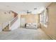 Cozy living room with staircase, neutral carpet, and bright natural light at 7734 W Terri Lee Dr, Phoenix, AZ 85035