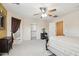 Spacious main bedroom featuring a ceiling fan, walk-in closet, and an attached bathroom at 7734 W Terri Lee Dr, Phoenix, AZ 85035