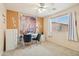 Bright home office with modern decor, a white desk, and a window offering ample sunlight at 7734 W Terri Lee Dr, Phoenix, AZ 85035