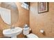 Modern powder room features mosaic tiling, a large round mirror and contemporary fixtures at 7734 W Terri Lee Dr, Phoenix, AZ 85035