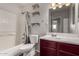 Bright bathroom featuring a shower-tub combo, floating shelves, and a vanity with storage at 8716 E Holly St, Scottsdale, AZ 85257