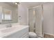 Clean bathroom featuring a walk-in shower, white vanity, and neutral tile flooring at 8716 E Holly St, Scottsdale, AZ 85257