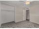 Neutral carpeted bedroom with a ceiling fan and closet; ready for your personal touches and design ideas at 8716 E Holly St, Scottsdale, AZ 85257