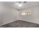 Comfortable bedroom with neutral paint and carpet with a ceiling fan and ample natural light at 8716 E Holly St, Scottsdale, AZ 85257