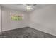A carpeted bedroom with a window that lets in natural light, creating a warm and inviting atmosphere at 8716 E Holly St, Scottsdale, AZ 85257