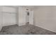 Bedroom with neutral walls and gray carpet with a closet space and a door to another room at 8716 E Holly St, Scottsdale, AZ 85257