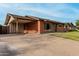 Charming brick house with a covered carport, green lawn, and inviting curb appeal at 8716 E Holly St, Scottsdale, AZ 85257