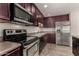 Modern kitchen featuring stainless steel appliances, sleek countertops, and rich wood cabinetry at 8716 E Holly St, Scottsdale, AZ 85257