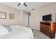 Comfortable bedroom includes a ceiling fan, dresser, and artwork, creating a cozy space at 9100 E Raintree Dr # 239, Scottsdale, AZ 85260