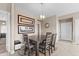 Dining room featuring a modern chandelier, wall art, and seating for four at 9100 E Raintree Dr # 239, Scottsdale, AZ 85260