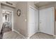 Hallway featuring wood-look tile, a closet, and access to the front door and a bedroom at 9100 E Raintree Dr # 239, Scottsdale, AZ 85260