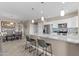 Elegant kitchen with granite countertops, stainless steel appliances, and bar seating seamlessly flowing to the dining area at 9100 E Raintree Dr # 239, Scottsdale, AZ 85260