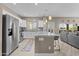 Bright, open kitchen with a large island, stainless steel appliances, and views into a comfortably furnished living area at 9100 E Raintree Dr # 239, Scottsdale, AZ 85260