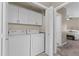 Laundry room with a full-size washer and dryer next to the entry to a bedroom at 9100 E Raintree Dr # 239, Scottsdale, AZ 85260