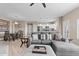 Comfortable living room with plush grey seating, seamlessly connects to the dining area and kitchen at 9100 E Raintree Dr # 239, Scottsdale, AZ 85260