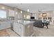 Open-concept living space featuring a kitchen island with bar seating and a spacious living room with recessed lighting at 9100 E Raintree Dr # 239, Scottsdale, AZ 85260