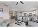 Open-concept living room seamlessly connects to the dining area and the kitchen, with modern, light fixtures at 9100 E Raintree Dr # 239, Scottsdale, AZ 85260