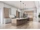 Spacious kitchen features a large island with seating, modern appliances, and elegant pendant lighting at 11140 W Prospector Dr, Queen Creek, AZ 85144