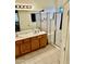Bathroom featuring dual sinks, spacious countertop, and tile flooring at 13783 W Caribbean Ln, Surprise, AZ 85379
