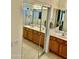 Bathroom boasts dual sinks, oak cabinets, walk-in shower, and tile flooring at 13783 W Caribbean Ln, Surprise, AZ 85379
