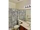 Cozy bathroom with black and white patterned shower curtain at 13783 W Caribbean Ln, Surprise, AZ 85379
