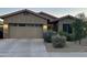 Charming single-Gathering home featuring a two-car garage and well-manicured landscaping at 13783 W Caribbean Ln, Surprise, AZ 85379