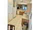 Bright and functional kitchen with tile flooring and appliances, conveniently located near other living areas at 13783 W Caribbean Ln, Surprise, AZ 85379