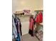 Walk-in closet features built-in shelving and rods for organized storage at 13783 W Caribbean Ln, Surprise, AZ 85379