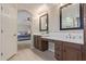 Bathroom featuring double sinks, vanity area, with access to the Primary bedroom, offering a convenient layout at 15324 W Windsor Ave, Goodyear, AZ 85395