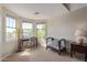 Bedroom with large windows offering views, accompanied by a desk and chair near a crib, all within a spacious layout at 15324 W Windsor Ave, Goodyear, AZ 85395